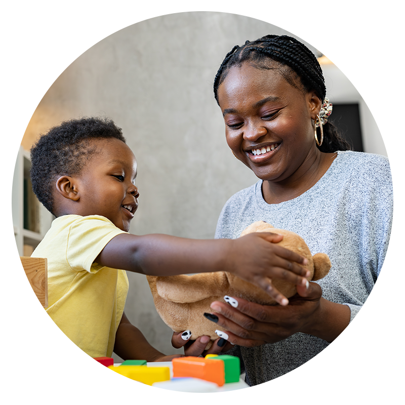 Picture of mother playing with kid and his teddy bear - Novara Healthcare - Houston, TX