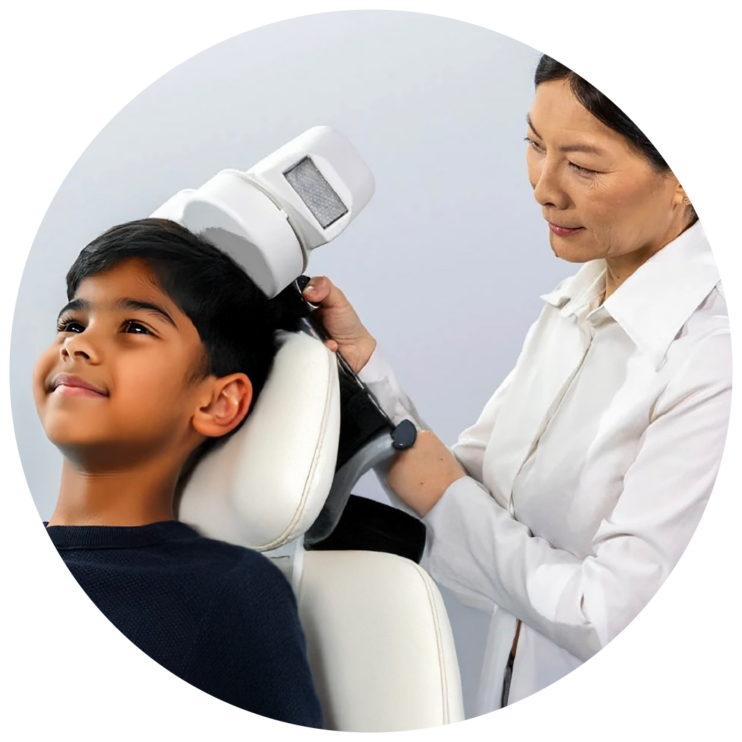 Doctor and nurse performing TMS Therapy on smiling kid